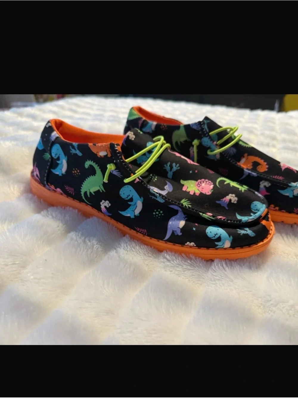 Kids Black Dinosaur Print Slip-On Shoes with Orange Sole